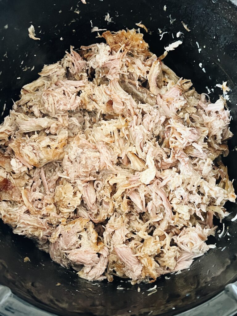 slow cooked pig shoulder that is fully cooked and shredded