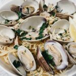 spaghetti alle vongole pasta with lemon and parsley in a bowl ready to be eaten